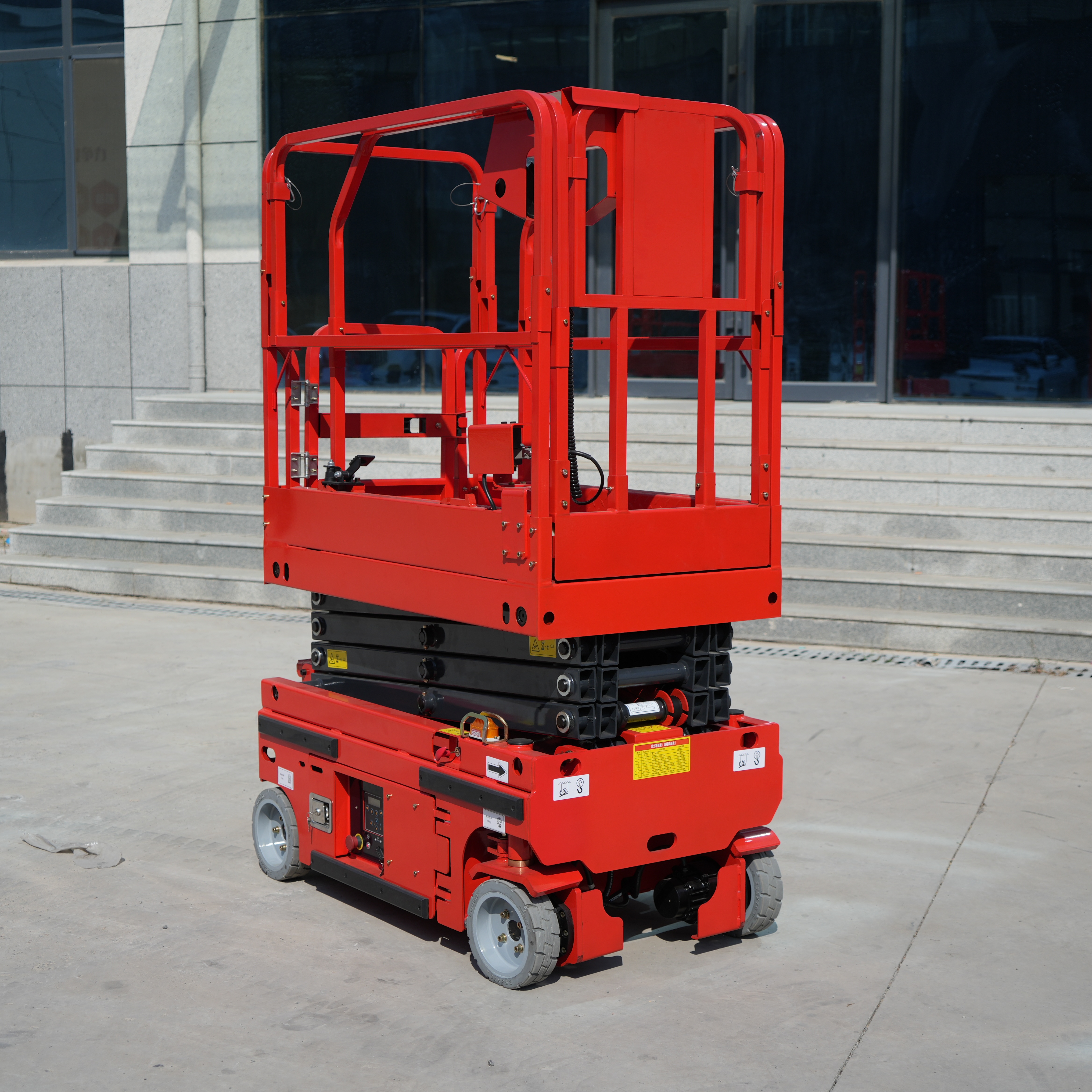 compact scissor lift performing warehouse maintenance tasks